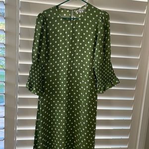 The color is green background with white polkadots. Very Art Deco looking dress.